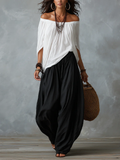 Conjunto de top blanco con hombros descubiertos y pantalones acampanados estilo farol