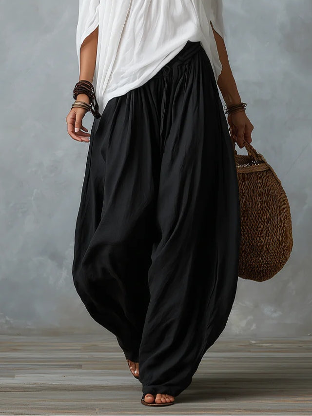 Conjunto de top blanco con hombros descubiertos y pantalones acampanados estilo farol